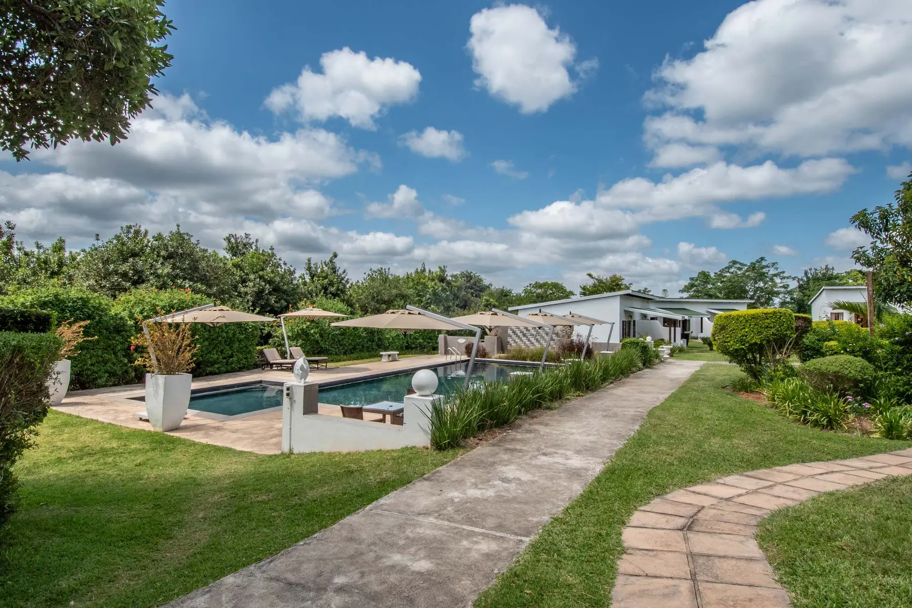 The swimming pool and gardens at Nut Grove Manor
